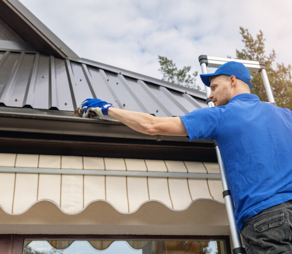 Handyman cleaning gutters