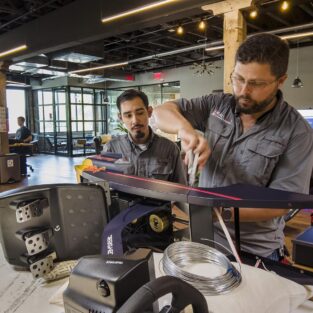 handyman assembling redbull play chair in the Dallas redbull office.