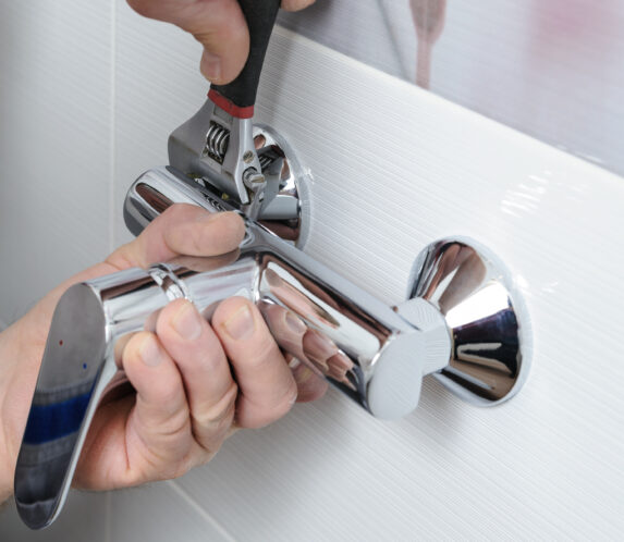 Man replacing a shower faucet valve