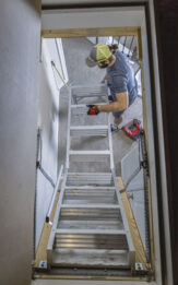Handyman Installing an attic ladder in a home